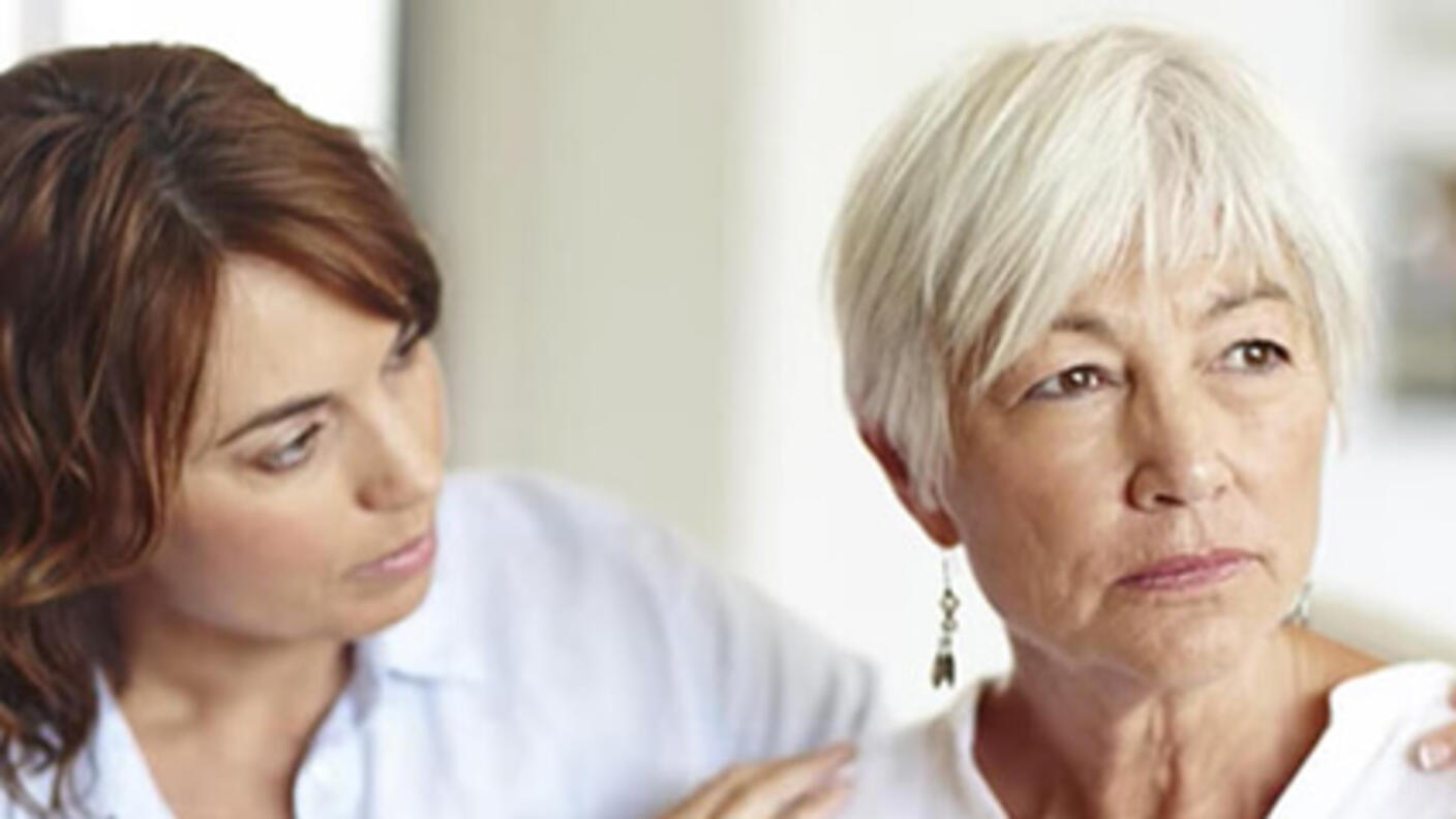 Young woman comforting an older worried woman