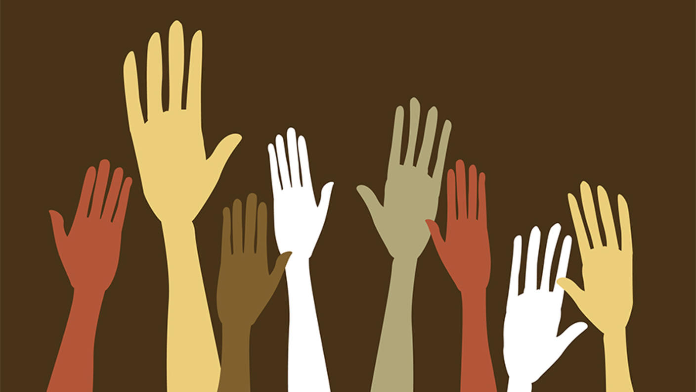 An illustration of different sized hands in various shades of brown, red, yellow and white on a brown background.