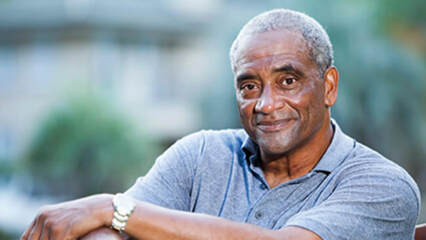 Smiling elderly man sitting outside