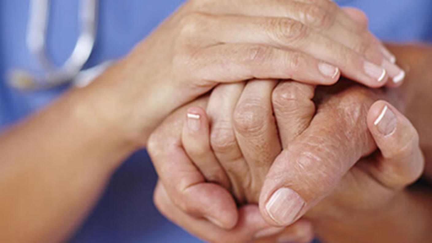 Close up shot of a doctor holding patient's hand