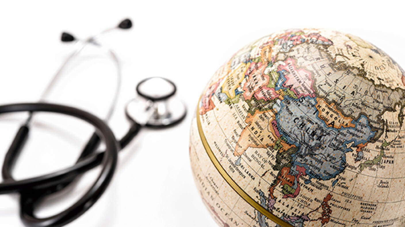 Photo of a stethoscope next to a globe