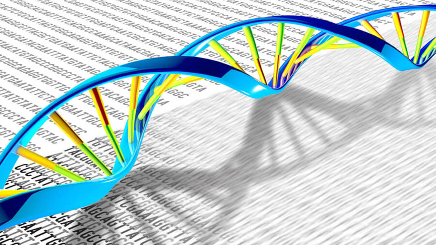 Artistic rendering of a DNA double helix in blue, green and yellow overlaying blurred genetic code text, representing the connection between DNA structure and genetic information.