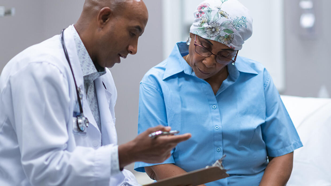 Older African-American woman in consultation with a doctor.