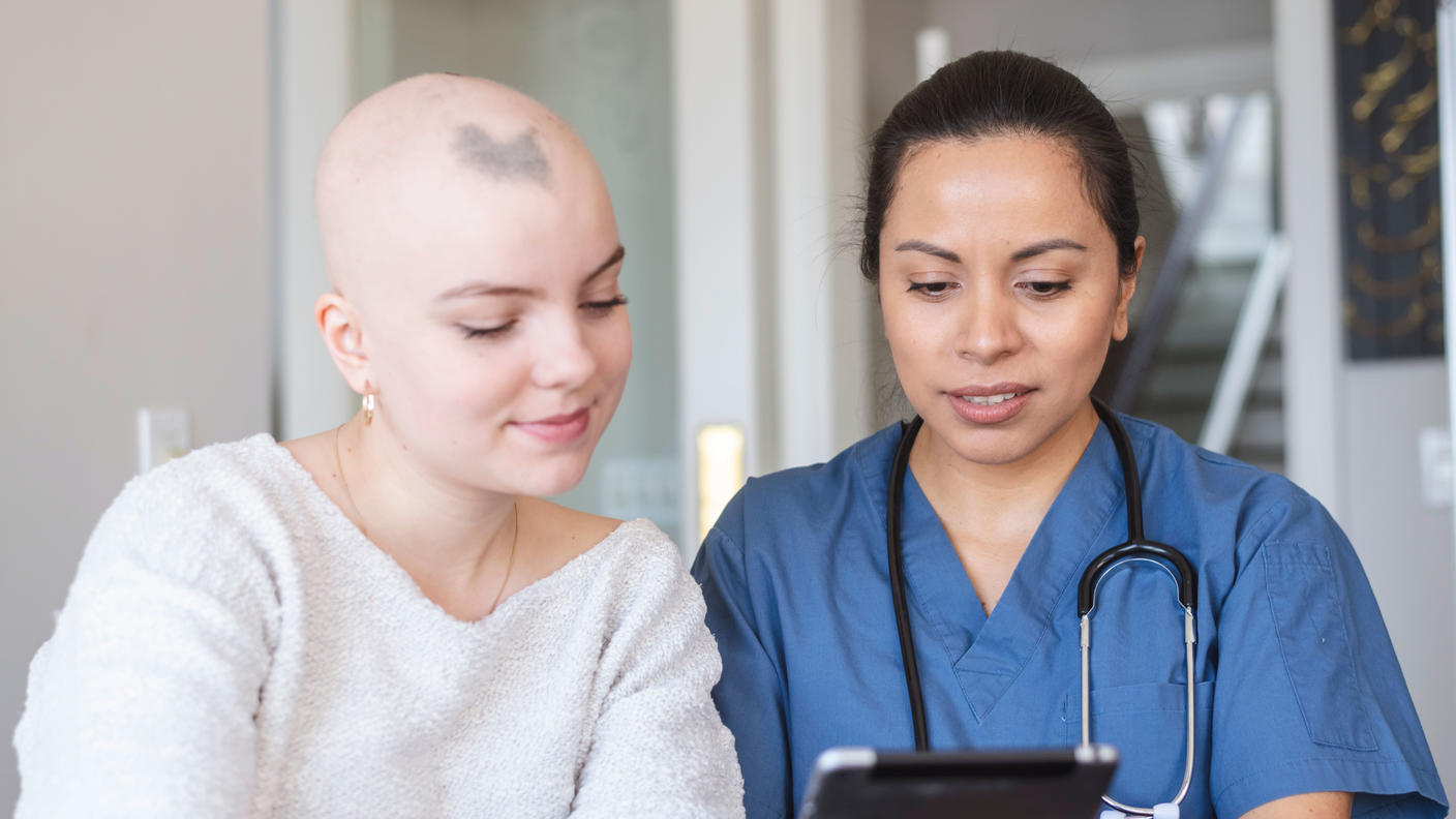 A woman with cancer is meeting with her female doctor.