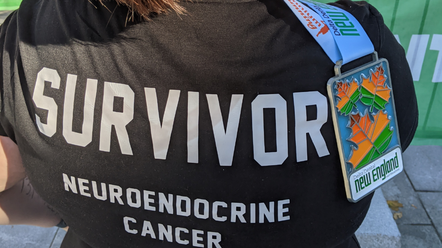 Bethany ross from the back with a "survivor neuroendocrine cancer" shirt