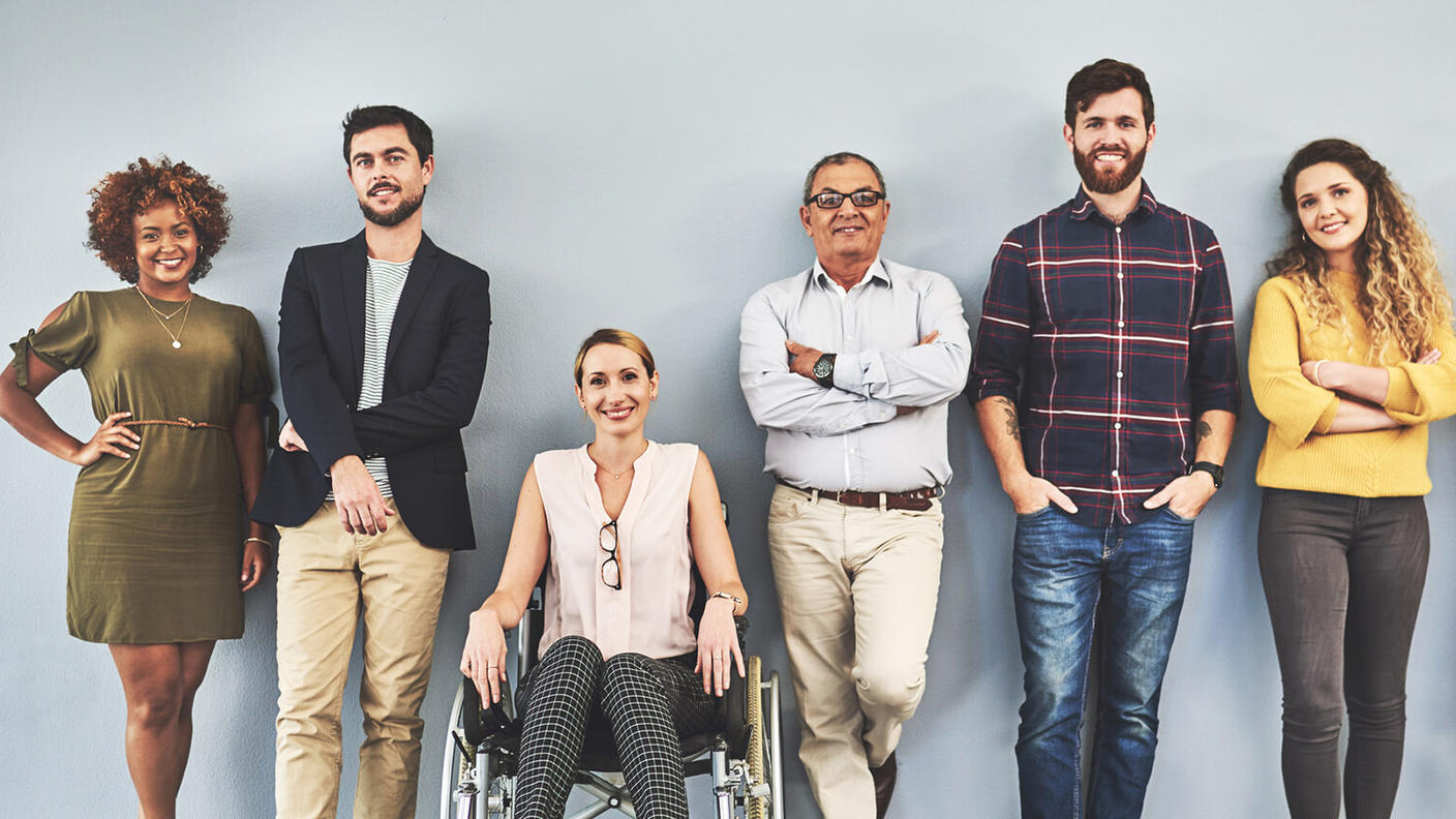 People standing against a wall. 