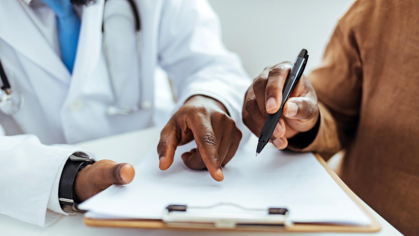 Understanding informed consent forms: A doctor and patient reviewing a medical form.