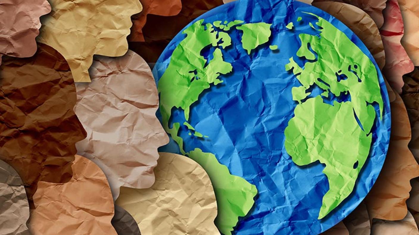 Cut paper collage of faces around a globe