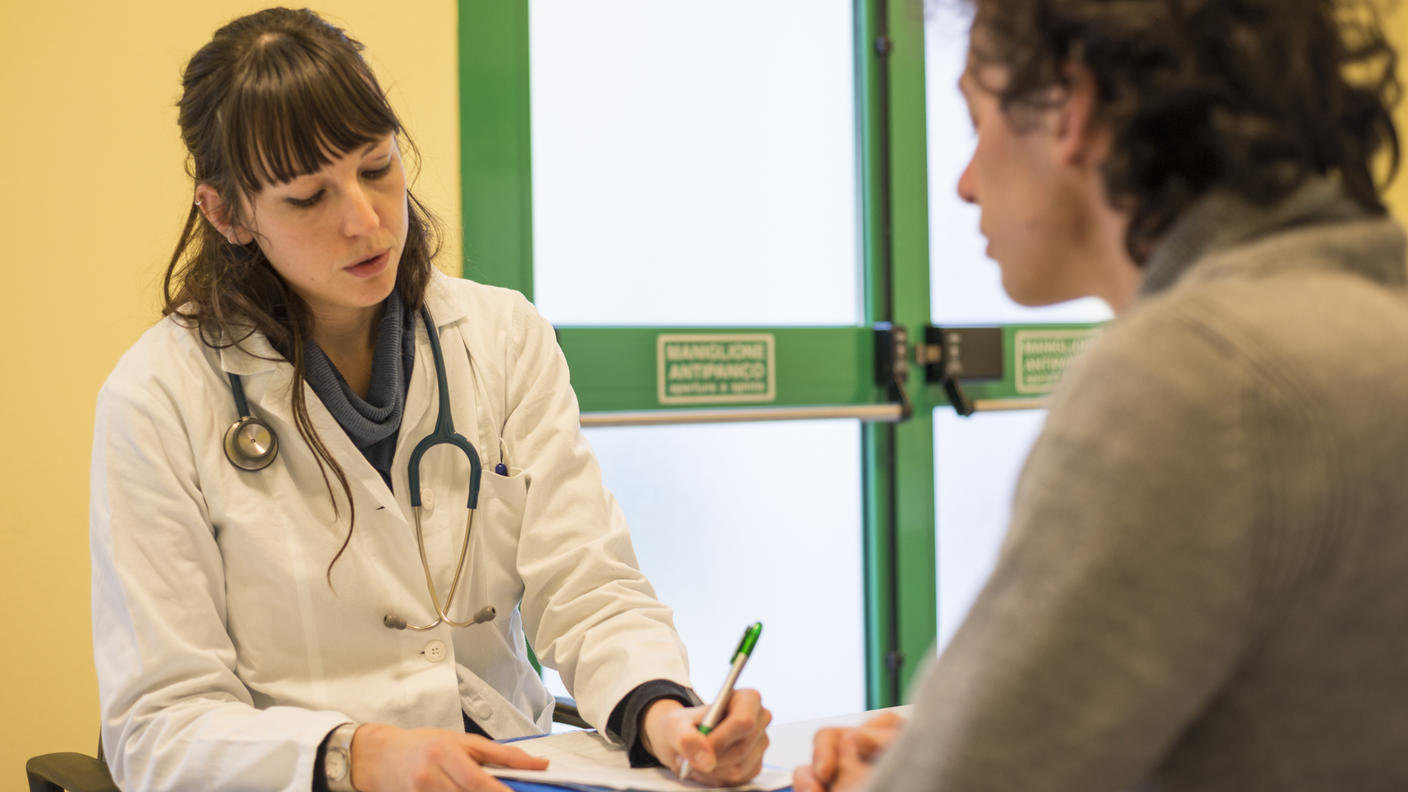 Doctor reviewing medical chart with patient.
