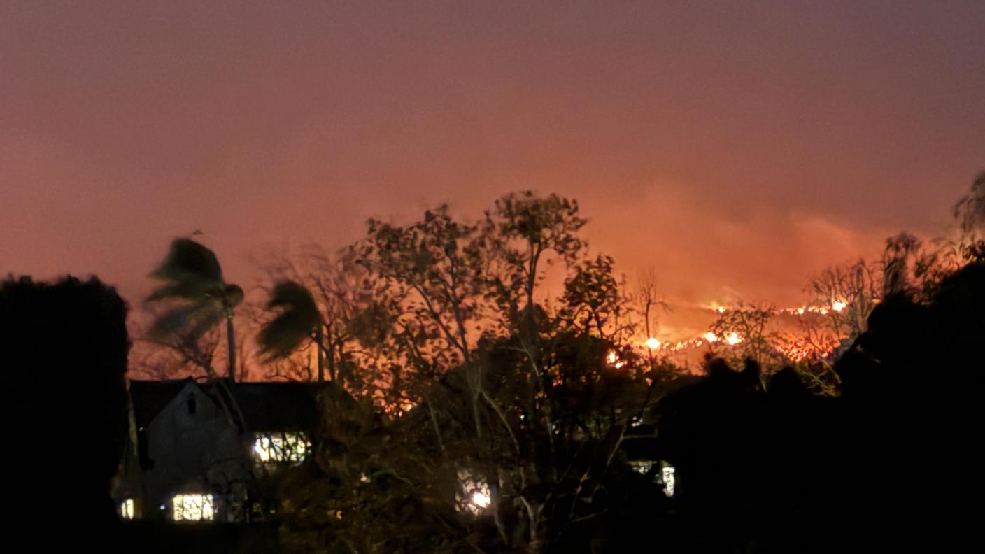 Wildfire with buildings in foreground