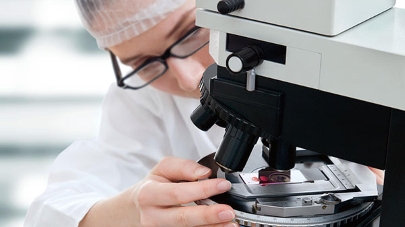 Microscopist analysing biopsy samples
