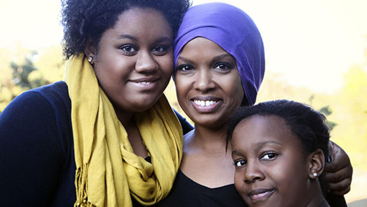 Mother in Headscarf Standing with Daughters
