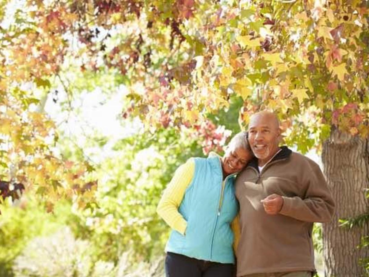 Man and woman standing under a tree in autumn