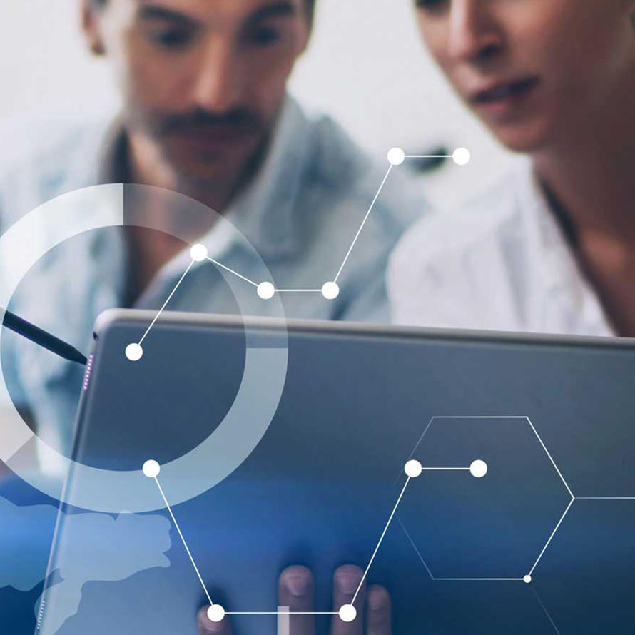 Two people looking at a laptop.